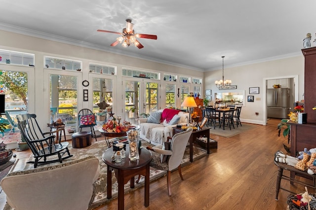 living room with wood-type flooring, ceiling fan with notable chandelier, french doors, and crown molding