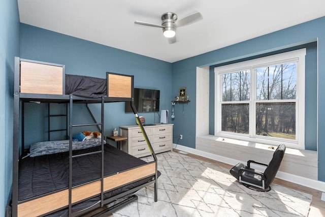 bedroom featuring baseboards and ceiling fan