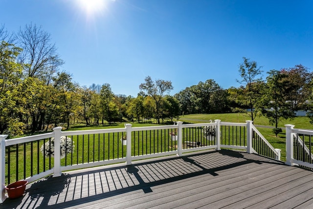 wooden deck featuring a yard