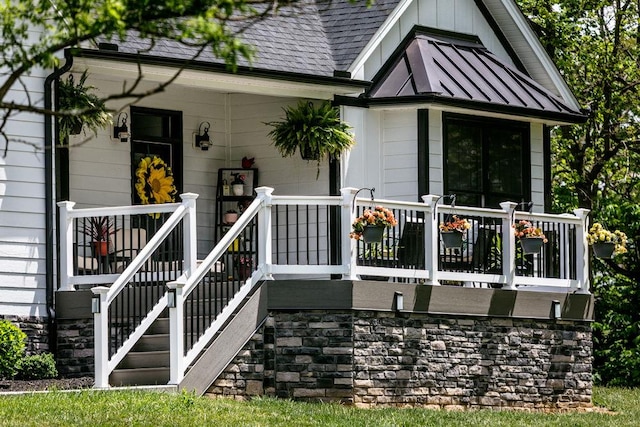 back of property featuring a standing seam roof and roof with shingles
