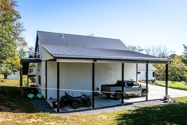 view of side of home with a carport and a lawn