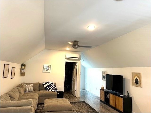living room with an AC wall unit, lofted ceiling, dark wood-style floors, a ceiling fan, and baseboards