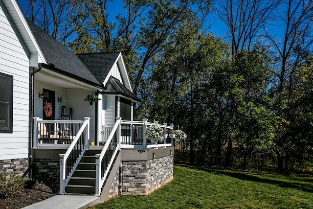 view of property exterior featuring a yard and covered porch