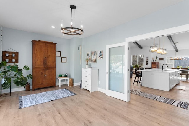 foyer entrance with a chandelier, light wood-style flooring, baseboards, beamed ceiling, and recessed lighting