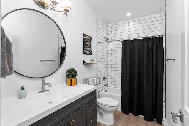 full bath featuring toilet, shower / bathtub combination with curtain, vanity, wood finished floors, and recessed lighting