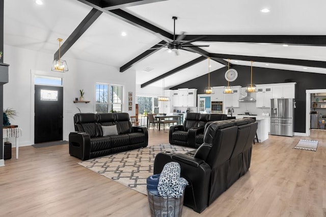 living area with beamed ceiling, light wood finished floors, recessed lighting, a ceiling fan, and high vaulted ceiling