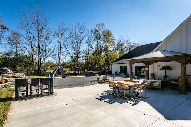 view of patio featuring an outdoor living space and exterior bar