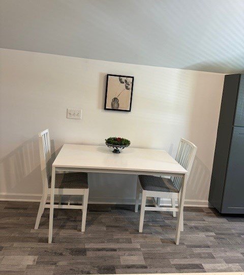 dining space featuring dark hardwood / wood-style flooring