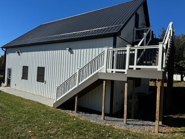 back of house with a deck, stairway, and metal roof