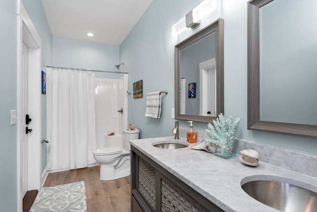 bathroom featuring vanity, hardwood / wood-style floors, and toilet