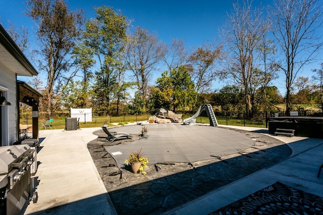 view of patio featuring grilling area and a hot tub