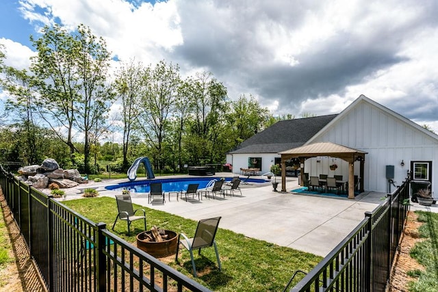 view of pool with a water slide, a gazebo, and a patio area