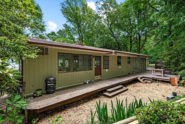 back of house with a wooden deck