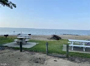 view of home's community featuring a beach view and a water view