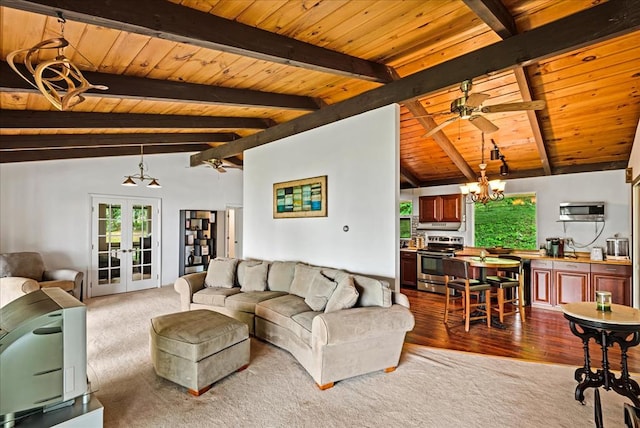 living room with french doors, ceiling fan with notable chandelier, vaulted ceiling with beams, light hardwood / wood-style floors, and wood ceiling