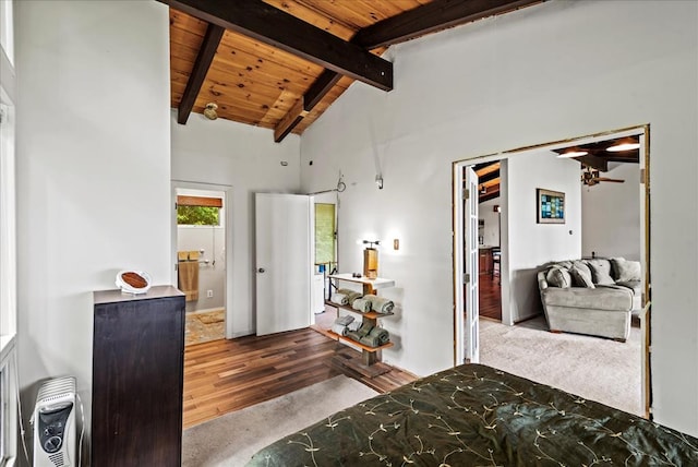 carpeted bedroom with beamed ceiling, wood ceiling, and high vaulted ceiling