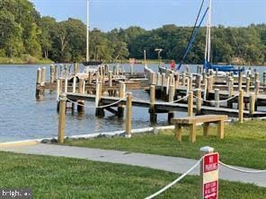 view of dock featuring a yard and a water view