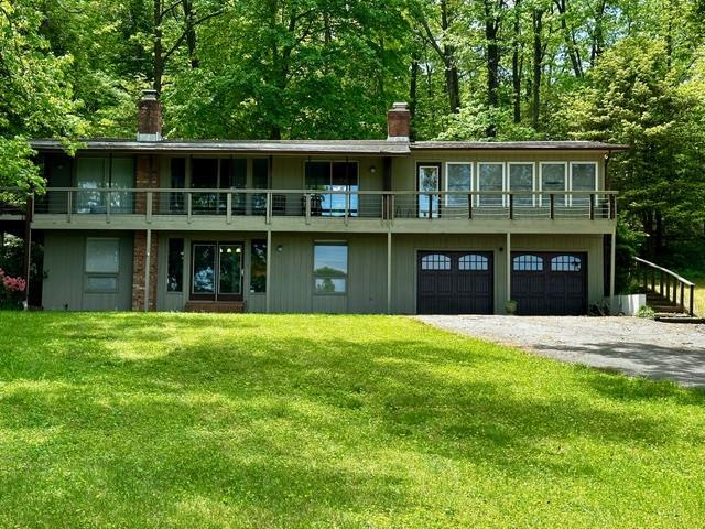 view of front of home with a front yard and a garage