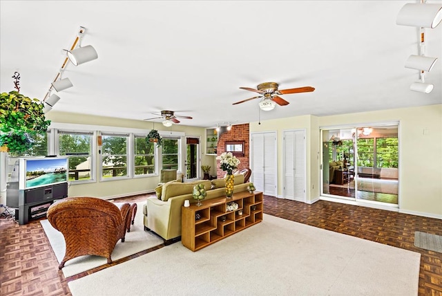 living room featuring ceiling fan and parquet flooring