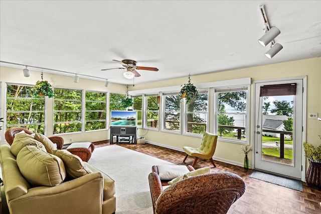 sunroom / solarium with ceiling fan and a wealth of natural light