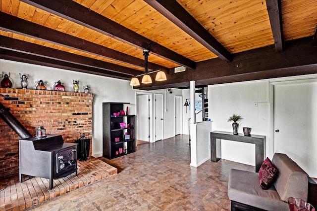 living room featuring beamed ceiling, a wood stove, and wood ceiling