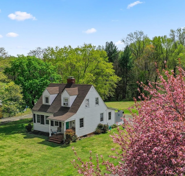 15498 Kings Hwy, Montross, VA 22520 - rear view of house featuring a chimney, a yard, and a wooded view