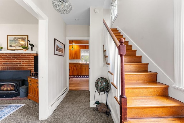 15498 Kings Hwy, Montross, VA 22520 - stairway with a wood stove, a baseboard radiator, and carpet flooring