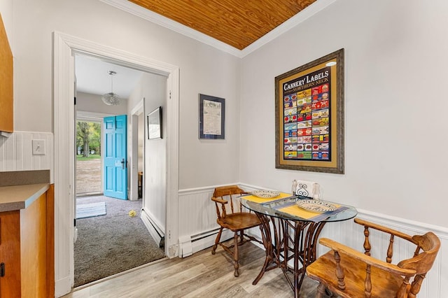15498 Kings Hwy, Montross, VA 22520 - dining area featuring wood finished floors, a wainscoted wall, baseboard heating, and ornamental molding