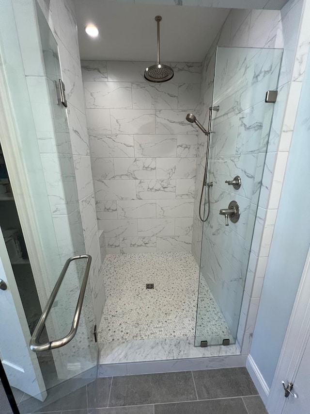 bathroom featuring tile patterned floors and a shower with door