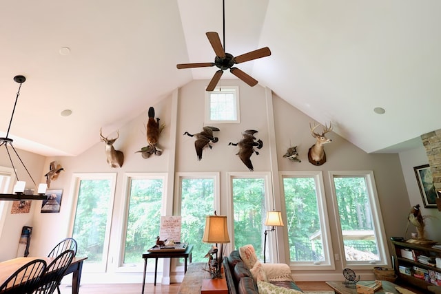 interior space with plenty of natural light, ceiling fan, and lofted ceiling