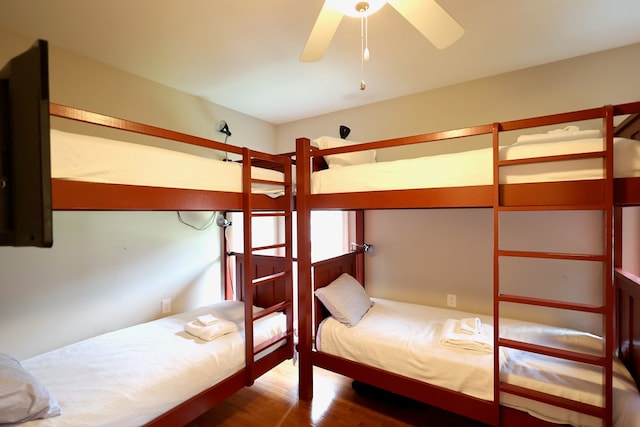 unfurnished bedroom featuring hardwood / wood-style flooring and ceiling fan