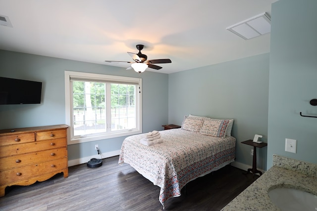 bedroom featuring ceiling fan, dark wood-type flooring, and sink