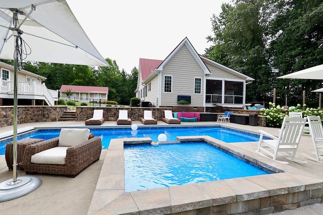 view of pool with a sunroom and an in ground hot tub