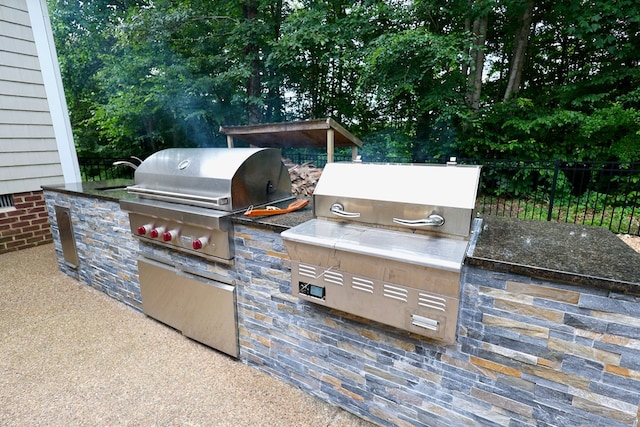 view of patio featuring area for grilling and a grill