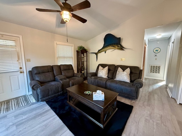 living room featuring hardwood / wood-style floors, vaulted ceiling, and ceiling fan