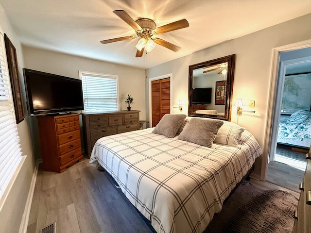 bedroom featuring hardwood / wood-style floors, ceiling fan, and a closet