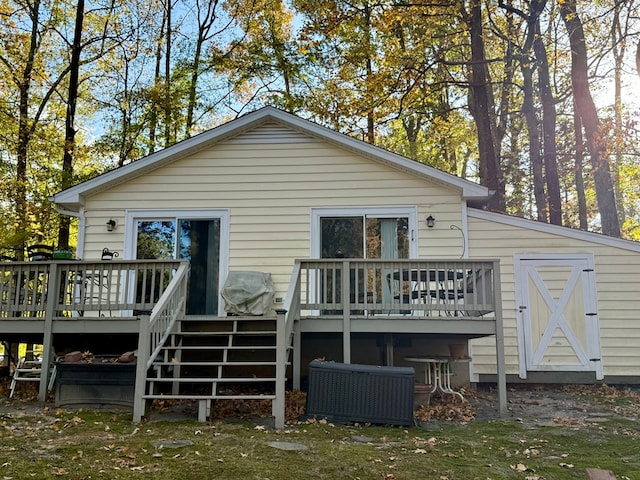 back of property with cooling unit and a deck