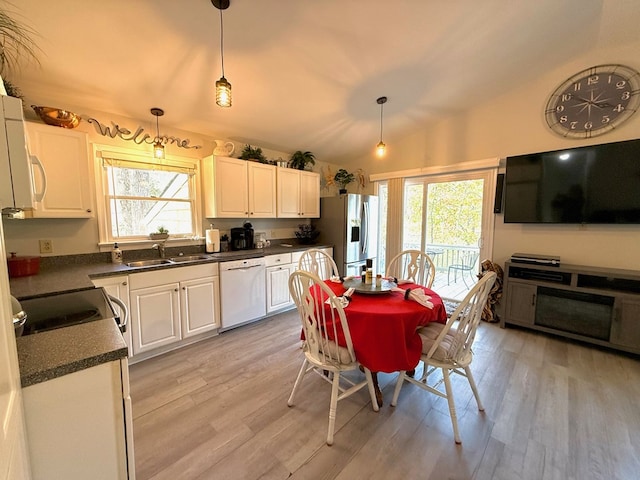 kitchen with white cabinetry, white appliances, hanging light fixtures, and light wood-type flooring