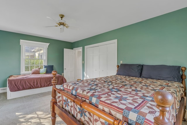 bedroom with carpet, a closet, a baseboard radiator, and ceiling fan