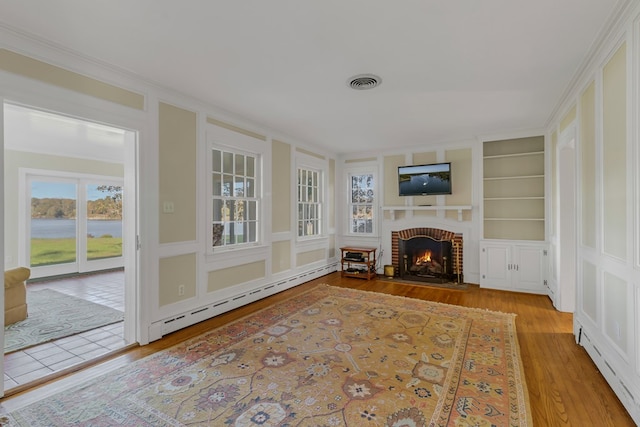 interior space featuring a baseboard radiator and a brick fireplace