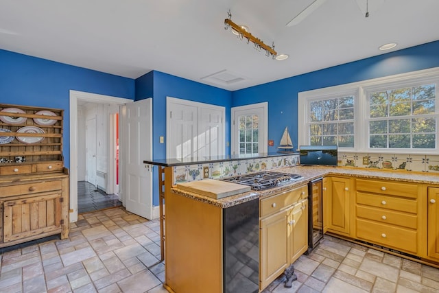 kitchen featuring wine cooler, decorative backsplash, kitchen peninsula, and stainless steel gas cooktop