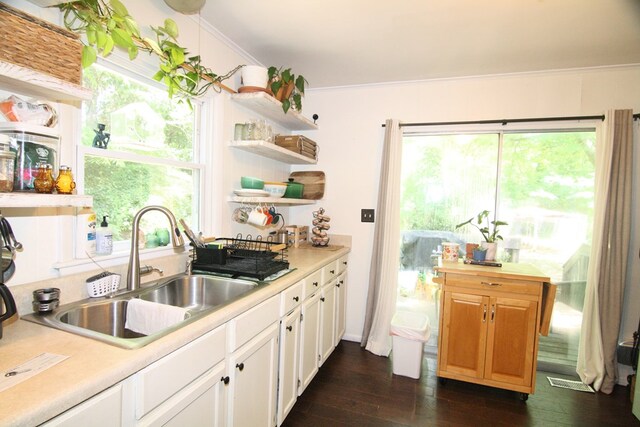 436 W Point Rd, Lancaster, VA 22503 - kitchen with open shelves, dark wood-style floors, light countertops, white cabinetry, and ornamental molding