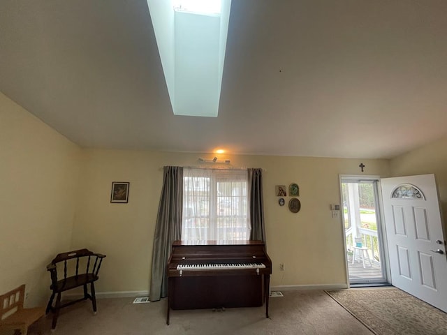 carpeted foyer with baseboards