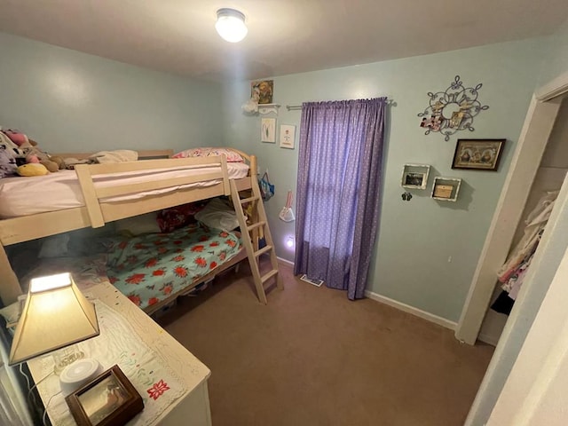 bedroom featuring carpet and baseboards