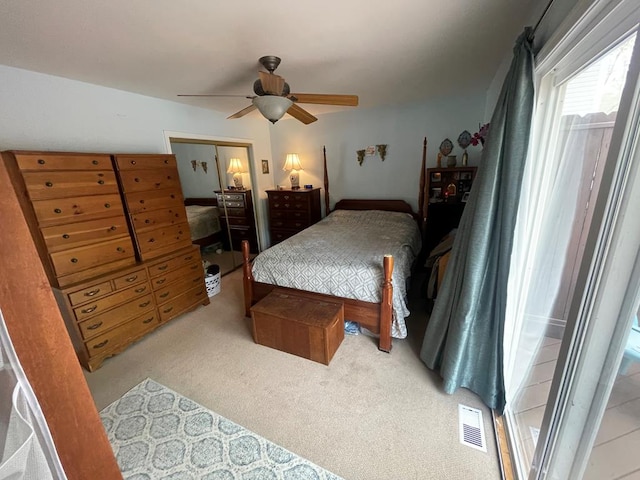 carpeted bedroom with ceiling fan and visible vents