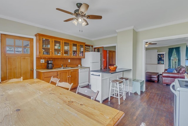 kitchen with ceiling fan, white appliances, dark wood-type flooring, a kitchen bar, and glass insert cabinets