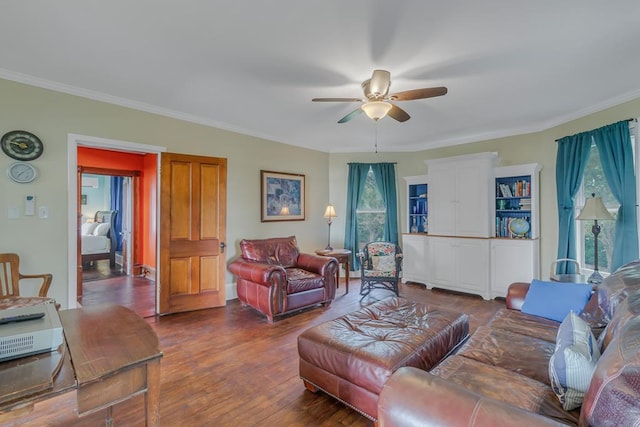 living area featuring ornamental molding, dark wood finished floors, and ceiling fan