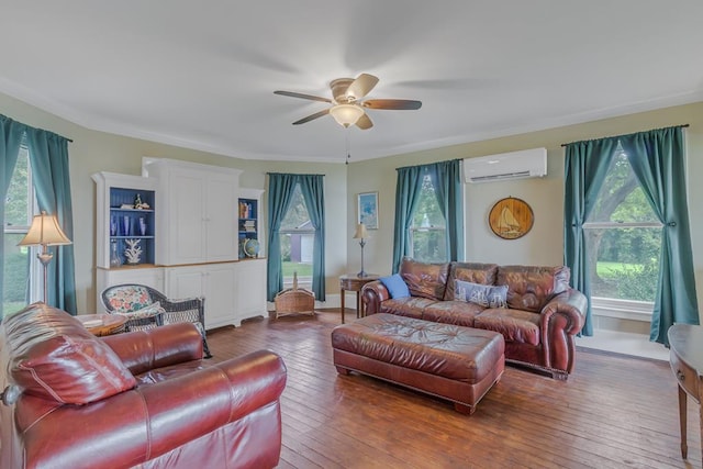 living area featuring a healthy amount of sunlight, hardwood / wood-style floors, and a wall mounted AC