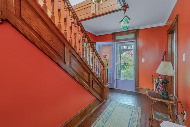 entryway with stairway, baseboards, ornamental molding, and wood finished floors