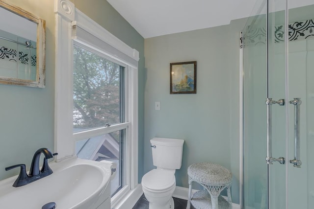 full bath with baseboards, a sink, and toilet